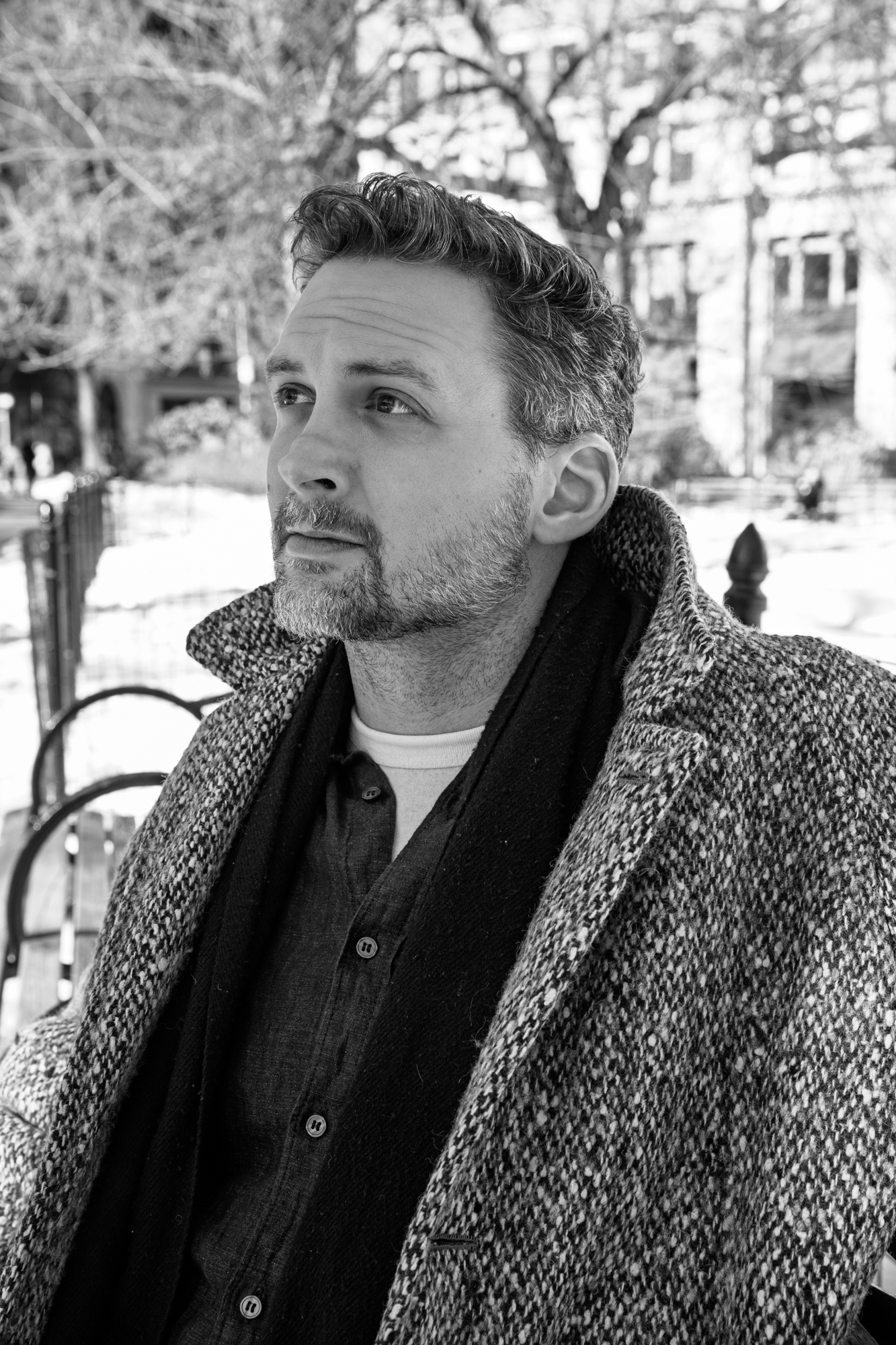 Image of author in front of stone wall.